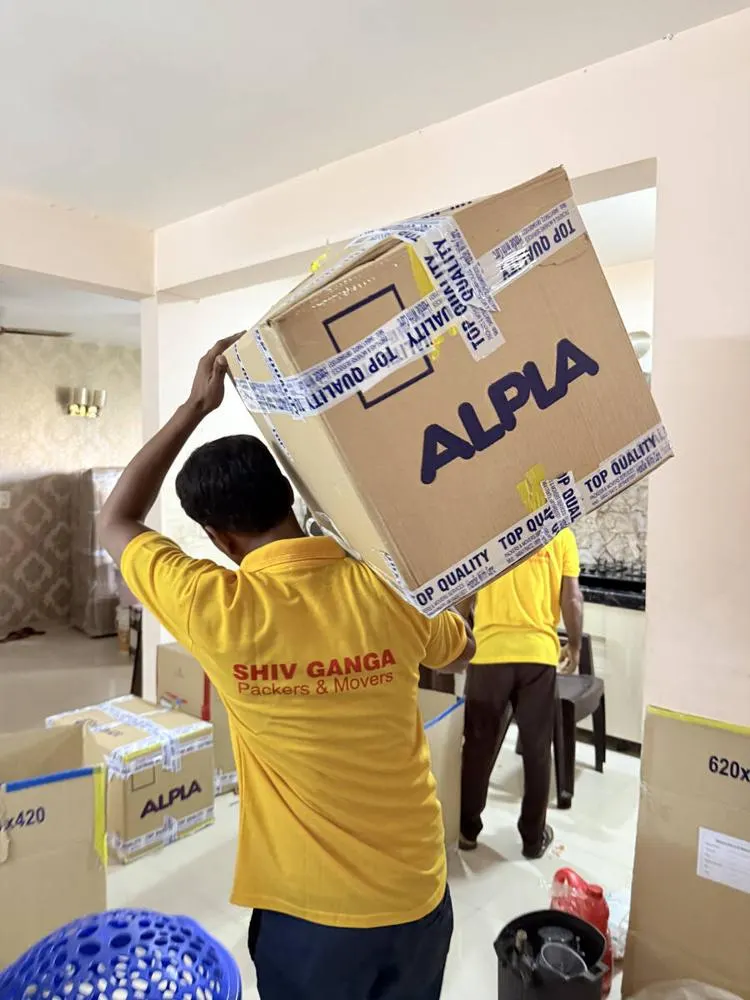 Worker carrying a sealed carton